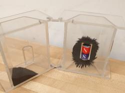 plexiglass box surrounding a bar magnet and iron filings