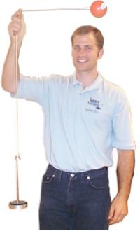 Man holding a string with a ball on one end and a weight on the other