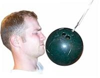 Bowling ball in front of a man's face