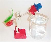 Drinking bird hovers over a beaker of water