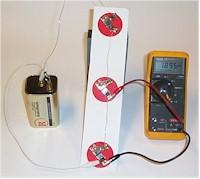 Three resistor and battery circuit; voltmeter.