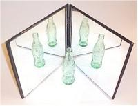 Two hinged mirrors and a glass bottle