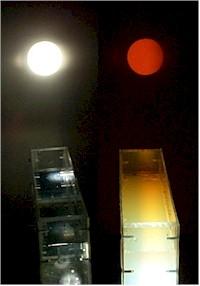 A beam of white light is passed through a clear tank. As Pine Sol is added, the beam is scattered for the sunset effect.