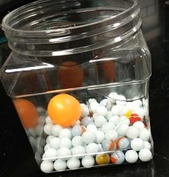 Jar full of marbles and a ping pong ball